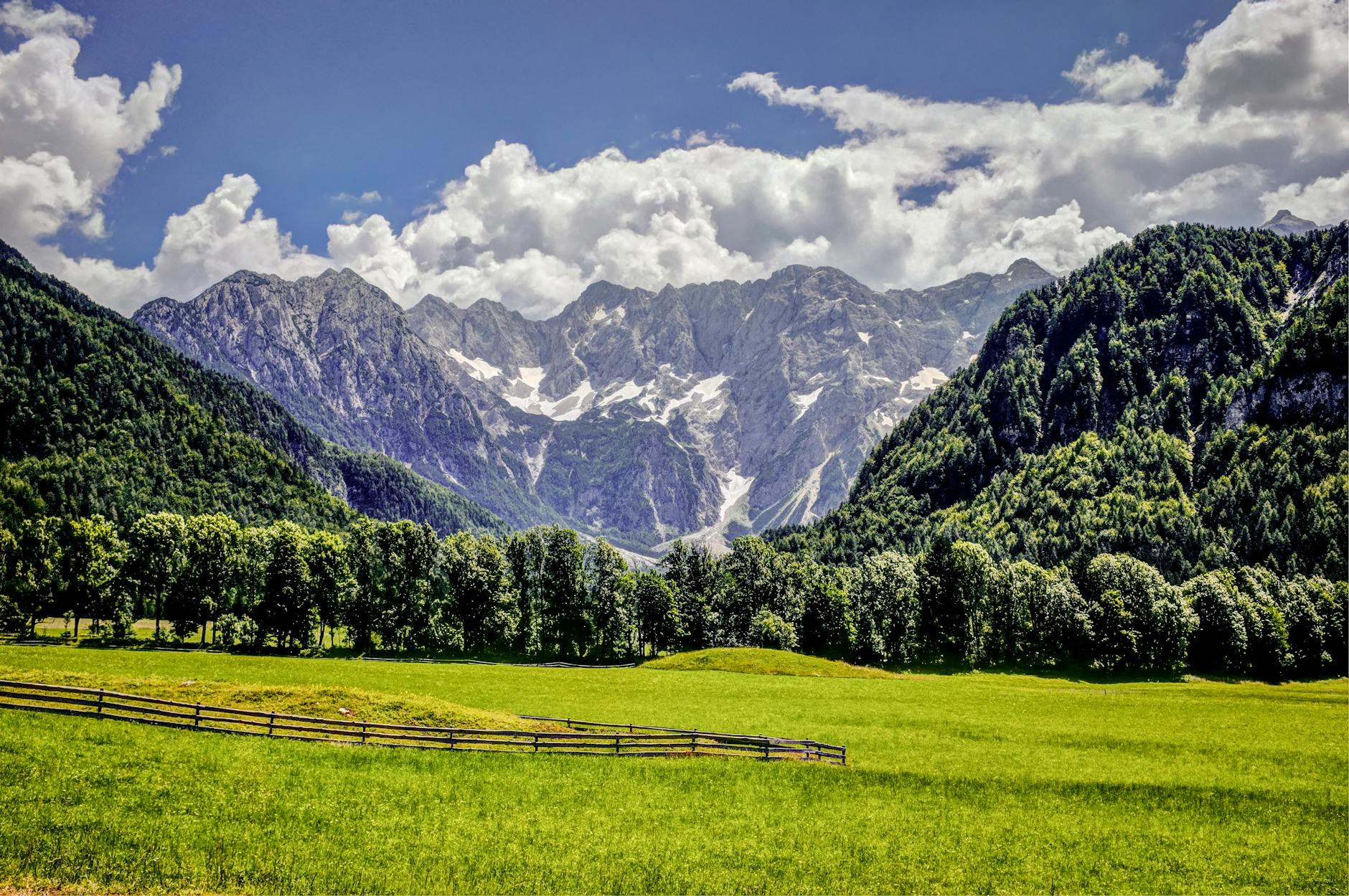 Beautiful Austrian Alps with lush green fields and snow-capped peaks