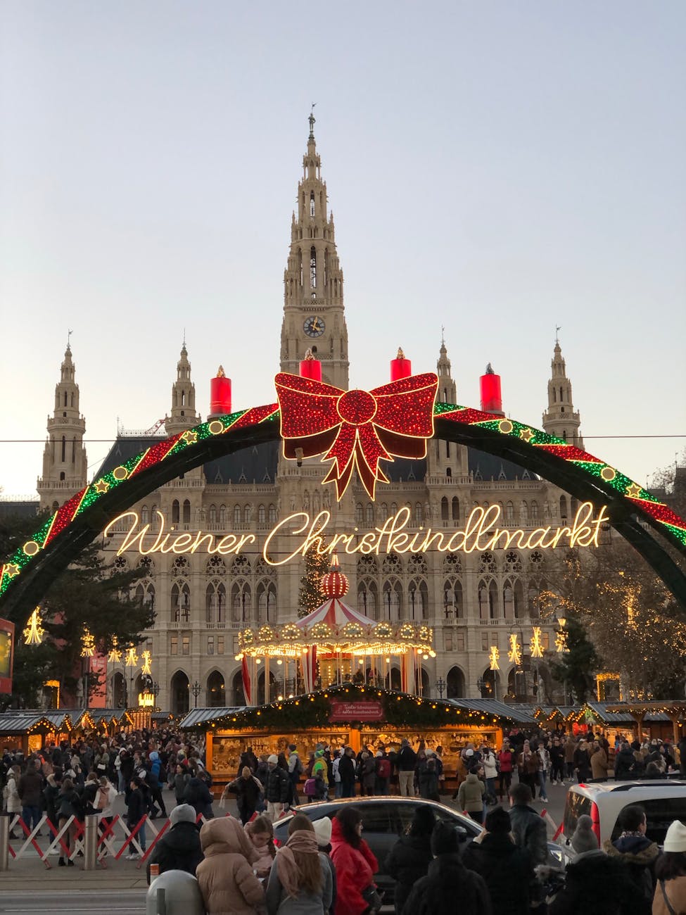 Festive Vienna Christmas market bustling with visitors under warm lights