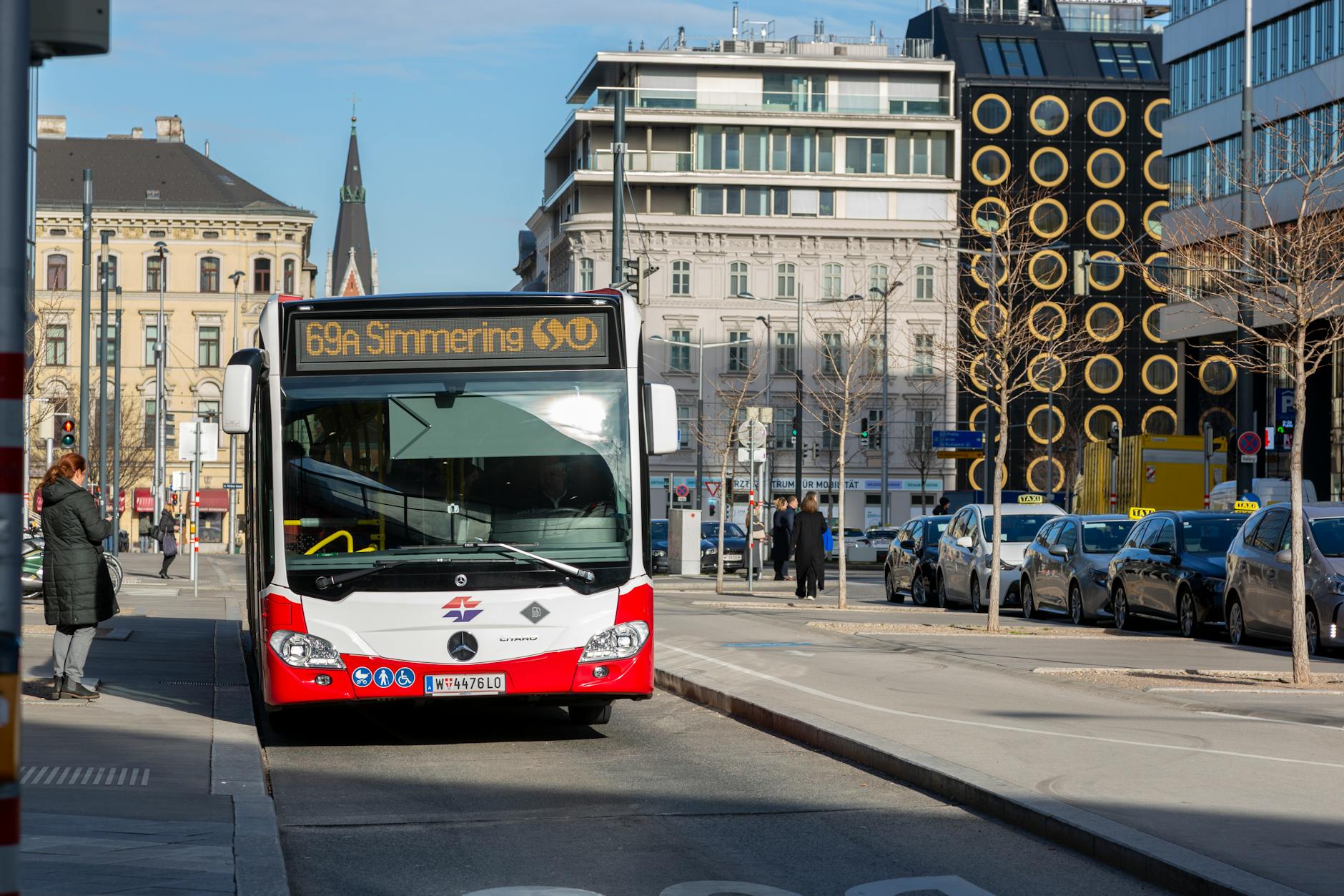 Vienna city bus on urban street in sunny weather