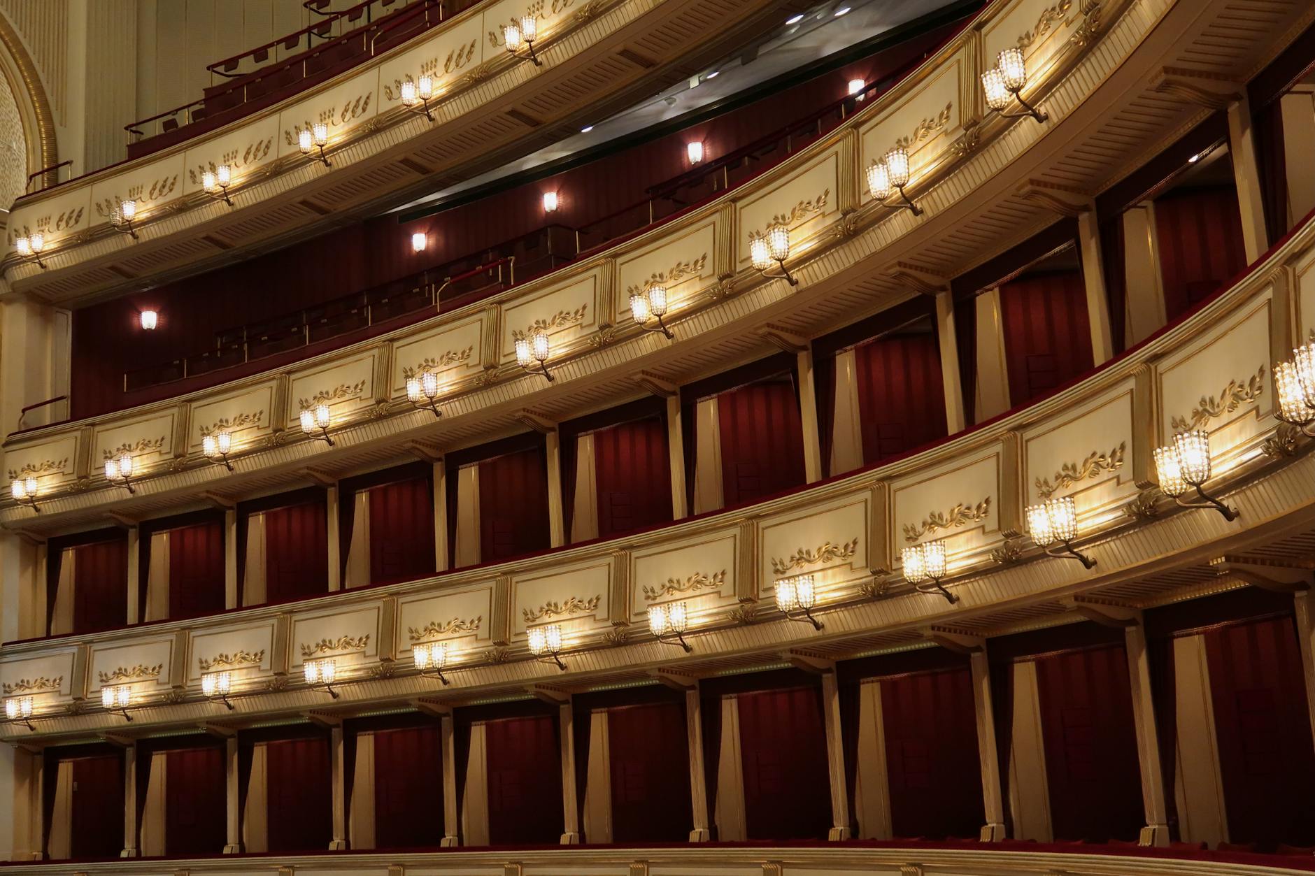 Ornate baroque theater interior with gilded balconies and red velvet seats
