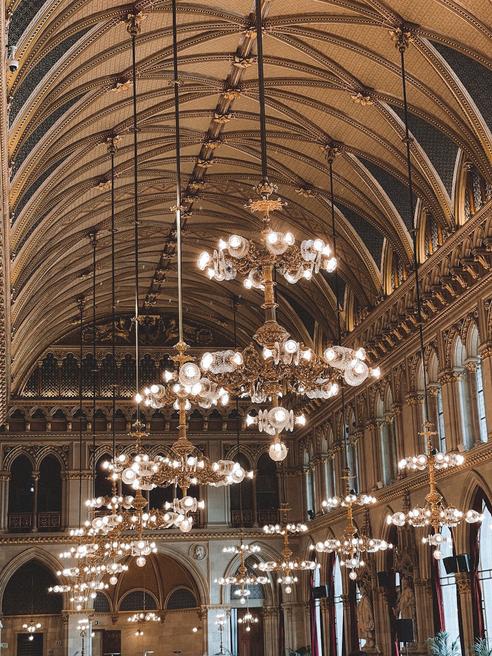 Magnificent crystal chandelier in Vienna concert hall with ornate ceiling details