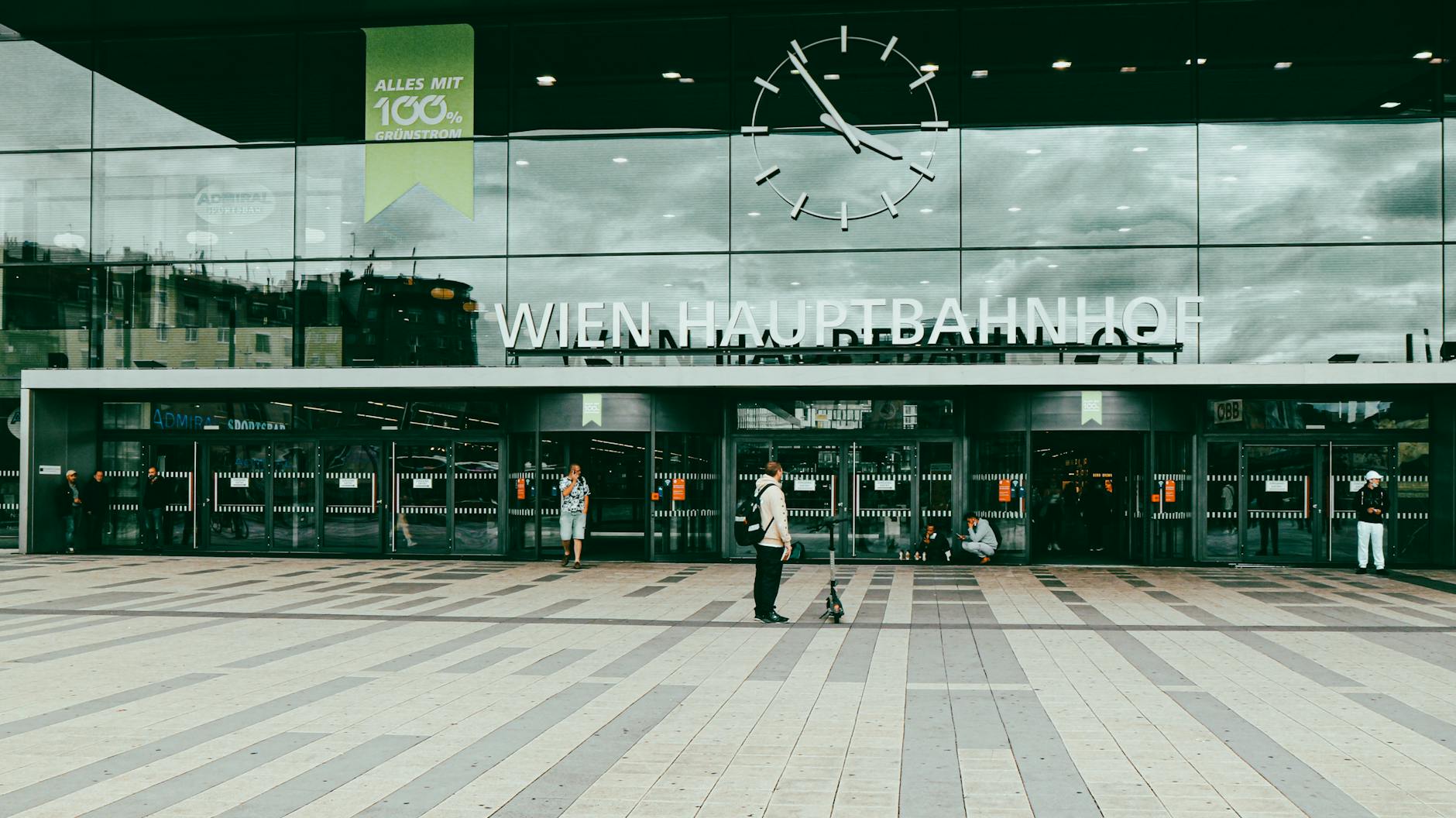 Entrance of Wien Hauptbahnhof with people and modern facade