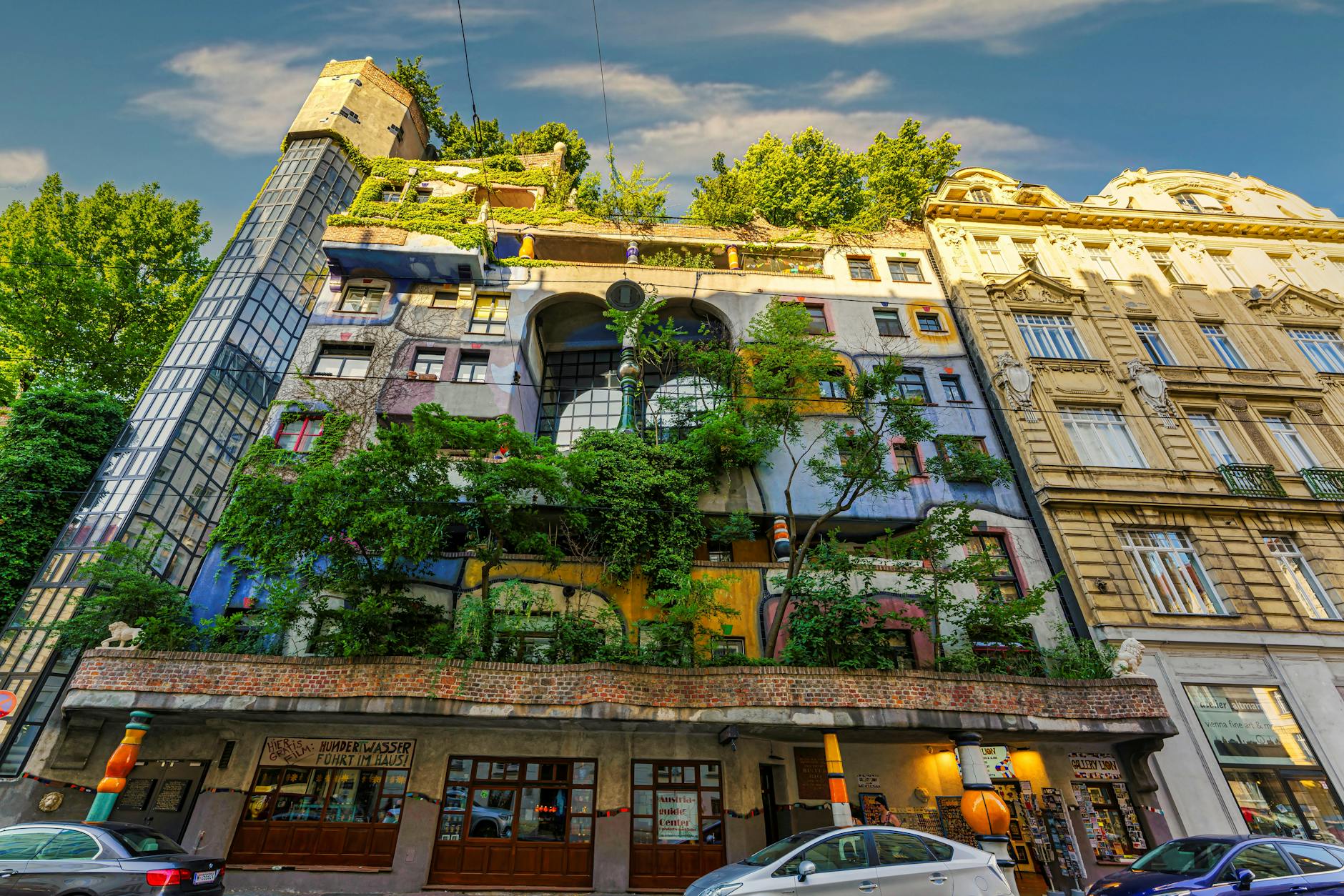 Hundertwasser House Vienna colorful facade with irregular windows organic shapes and growing trees