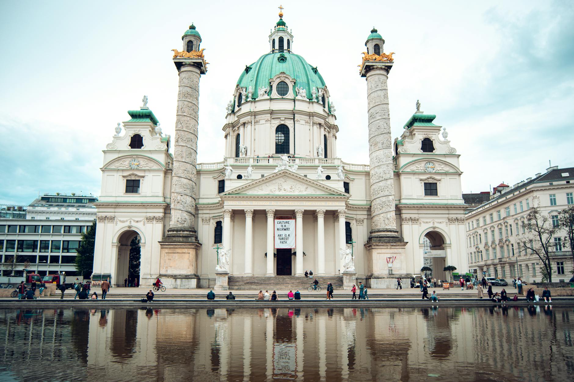 Karlskirche reflected in its pool on a windless day — golden hour is the magic window