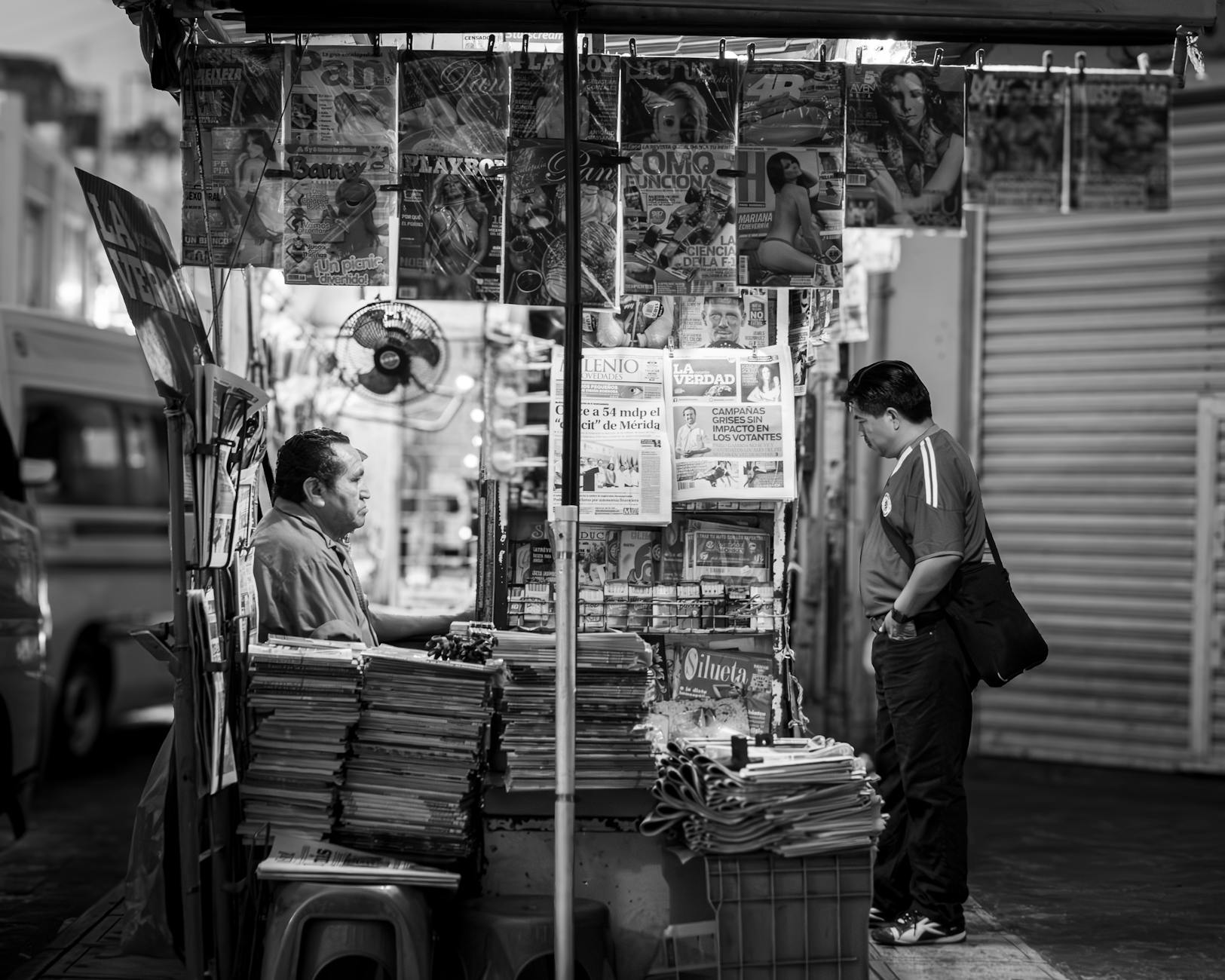 Newspapers on wooden racks — the coffeehouse offers them free; locals read for hours