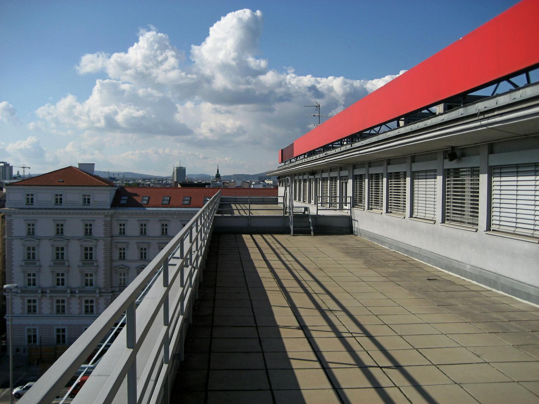 Rooftop terrace bar overlooking the Vienna skyline at sunset