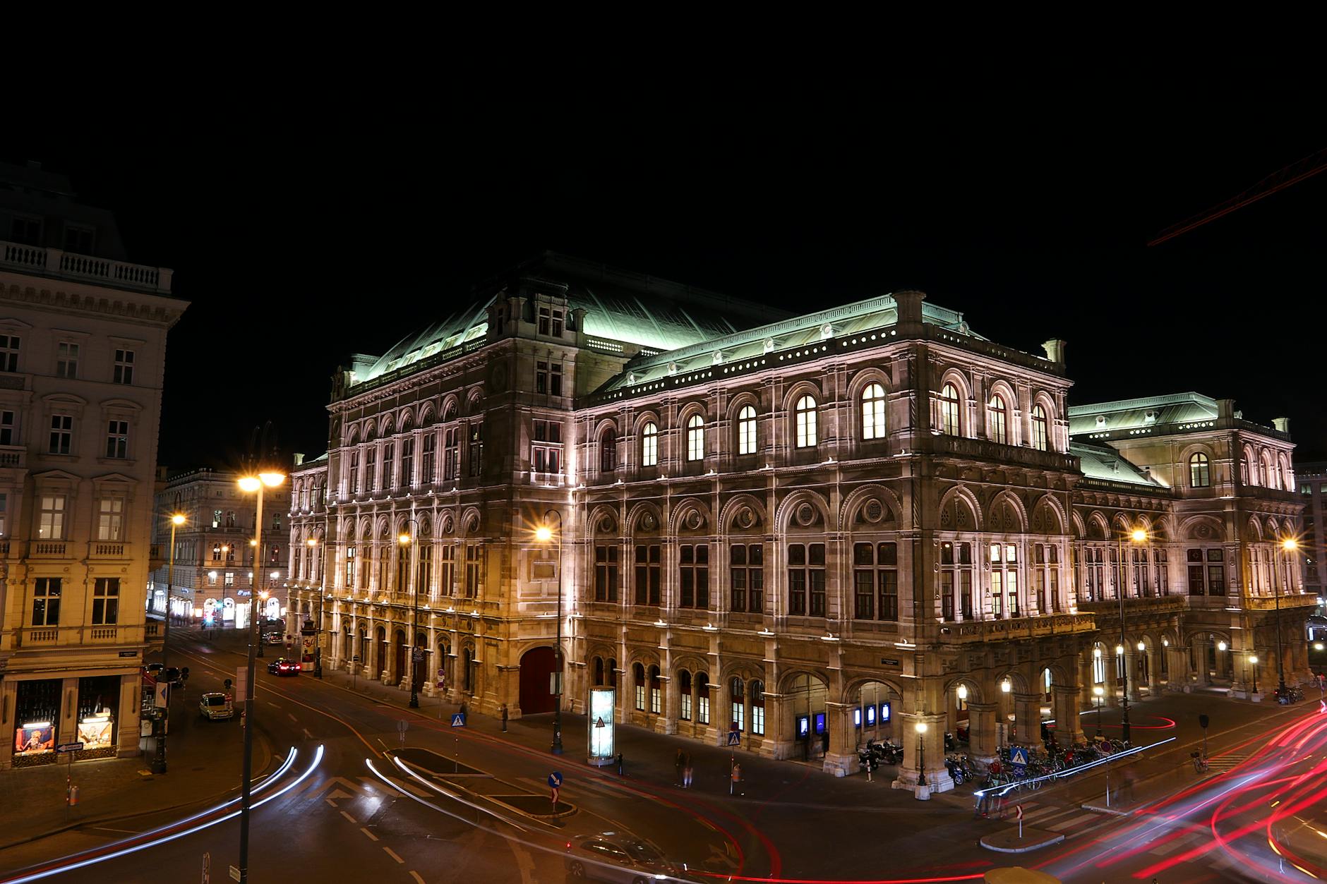 Illuminated Vienna State Opera at night showcasing famous architecture