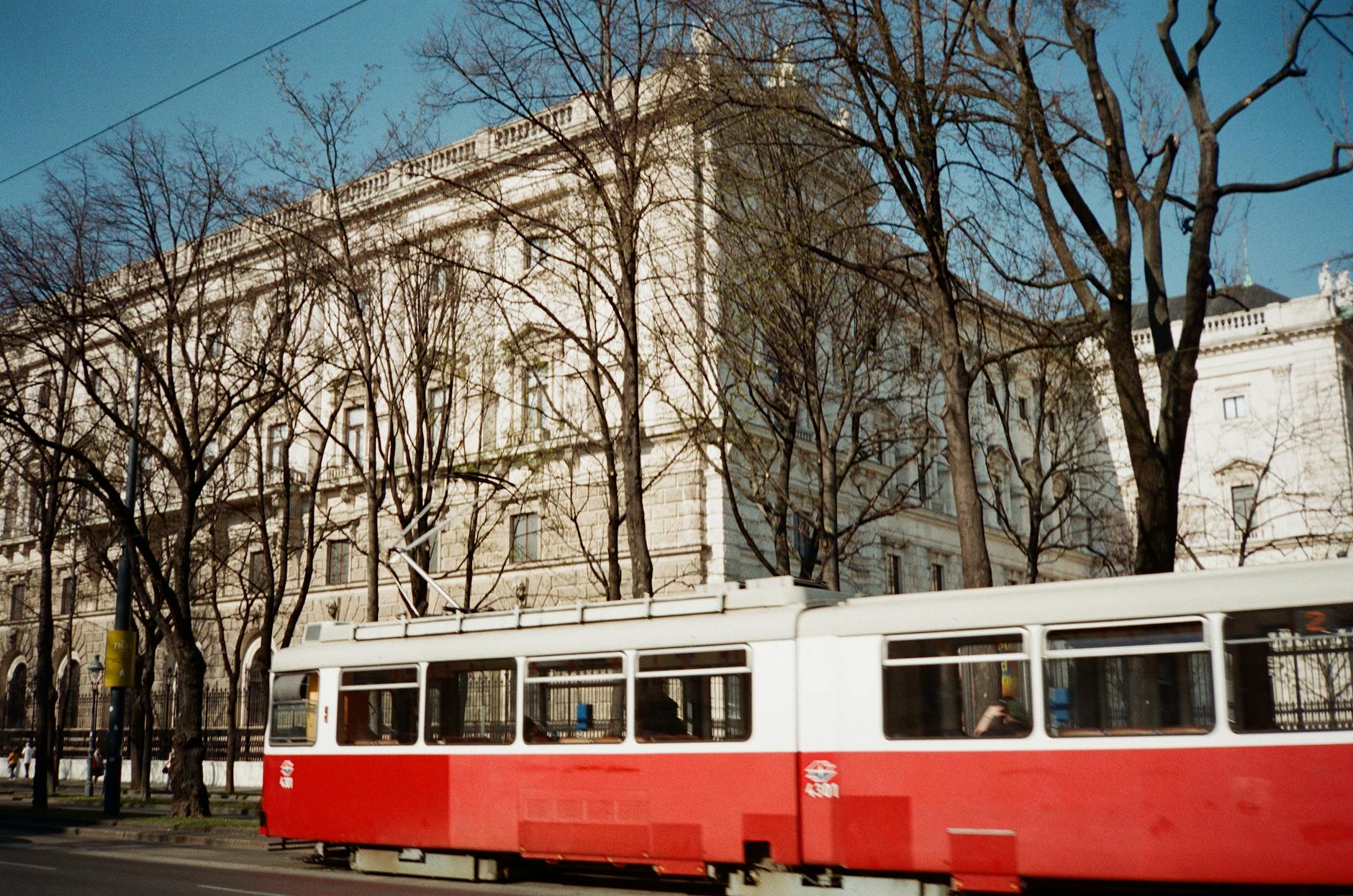 Vintage tram against historic Vienna architecture