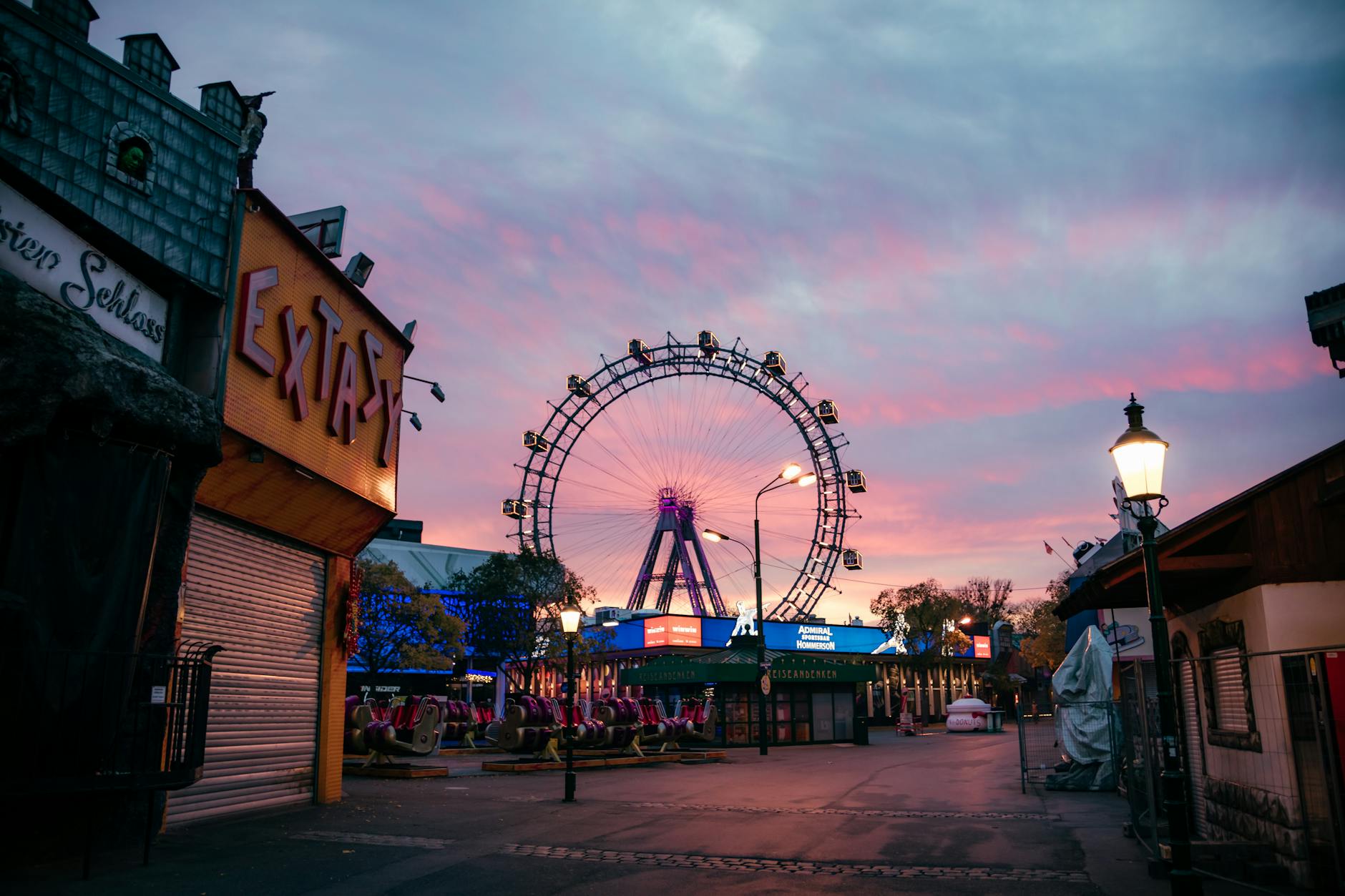 The illuminated Vienna Ferris Wheel at dusk in Prater, Leopoldstadt — a family-friendly area to stay
